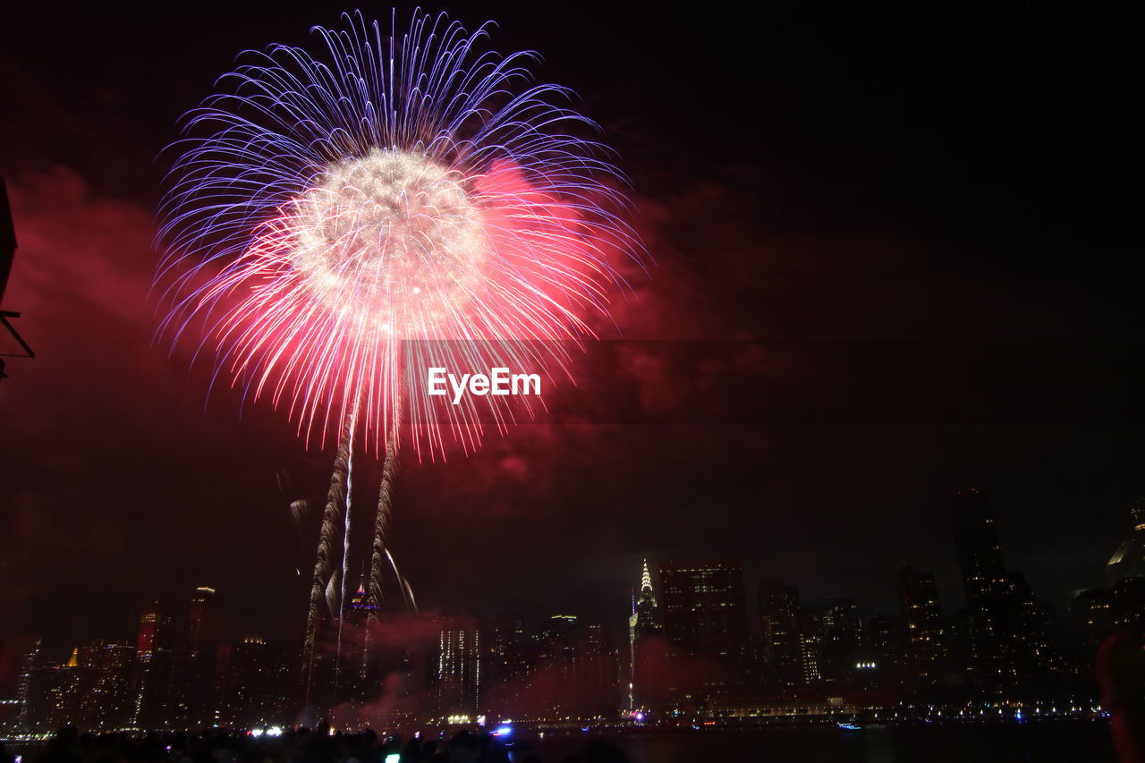 Low angle view of firework display at night