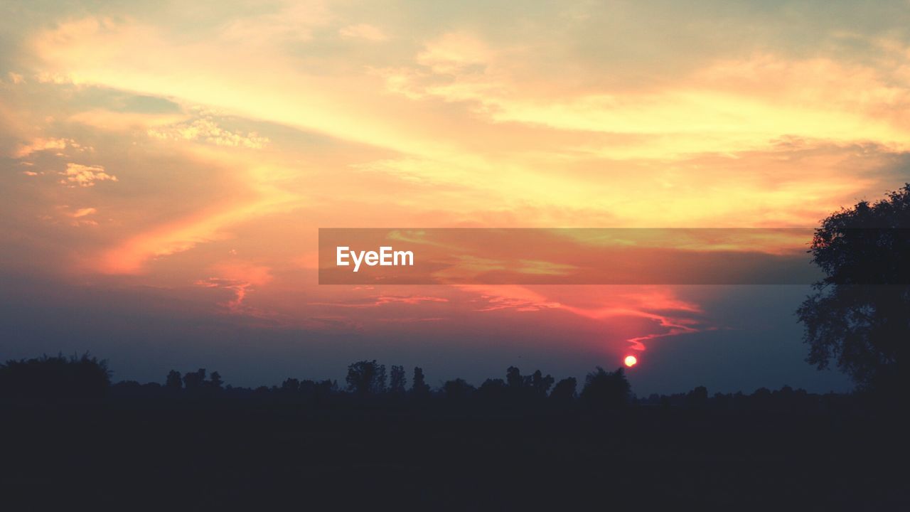 SCENIC VIEW OF SILHOUETTE LANDSCAPE AGAINST ROMANTIC SKY