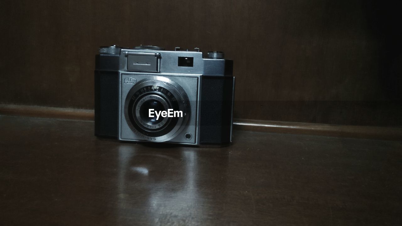 CLOSE-UP OF CAMERA ON TABLE IN BATHROOM