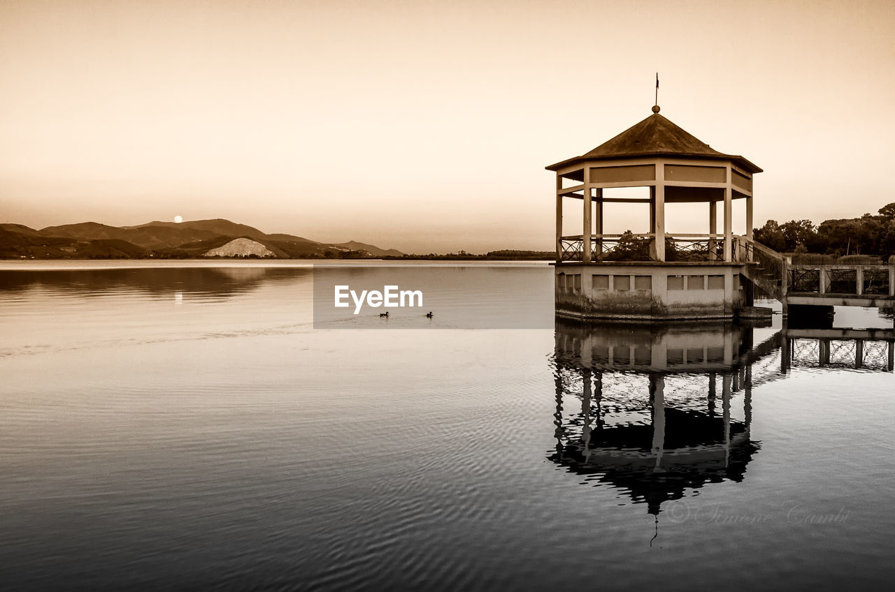 GAZEBO IN LAKE AGAINST BUILDING