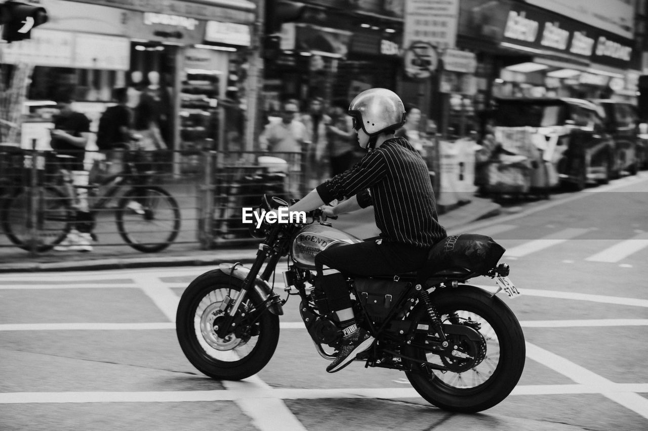 MAN RIDING BICYCLE ON STREET