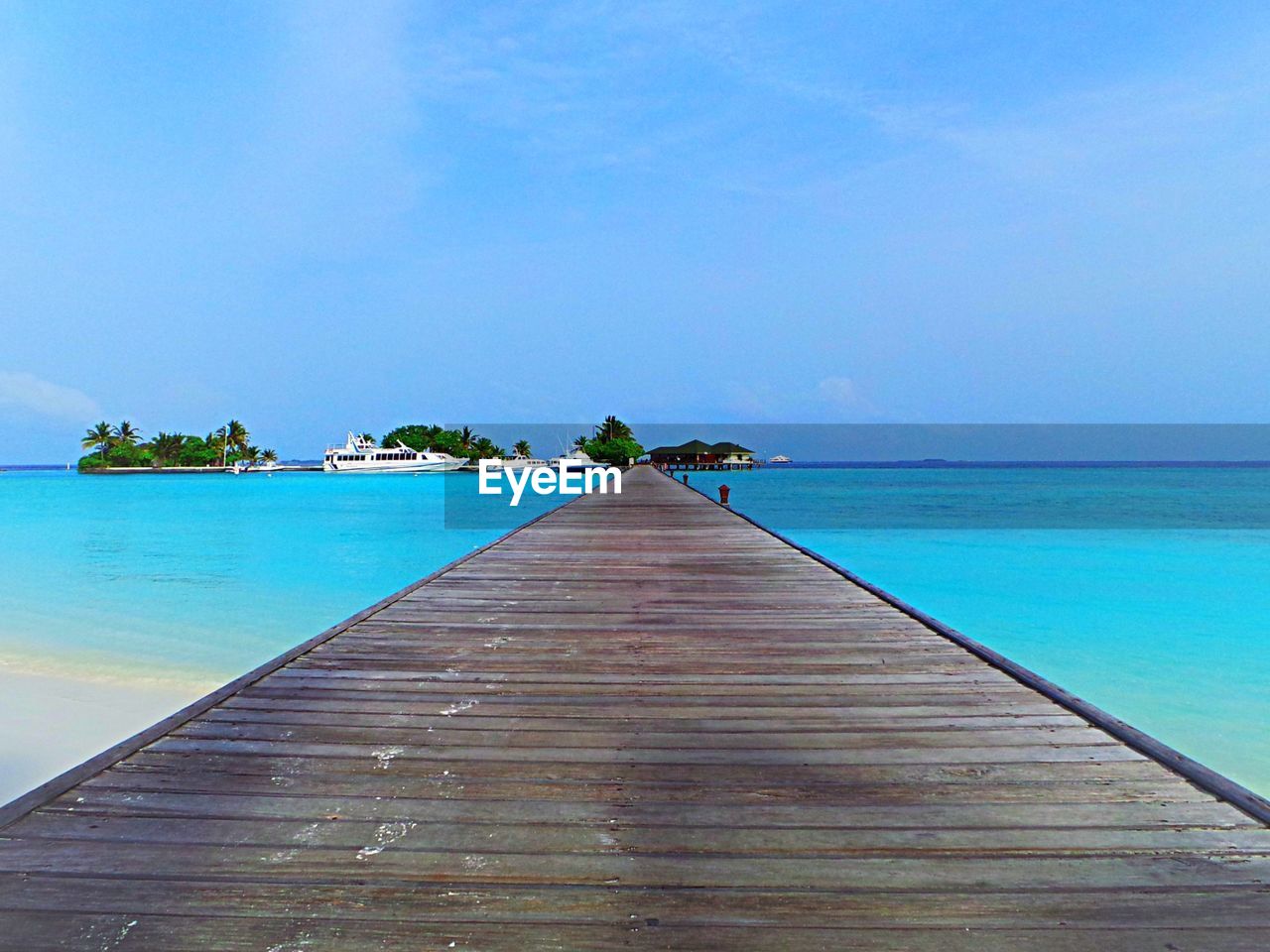 Scenic view of sea against clear blue sky