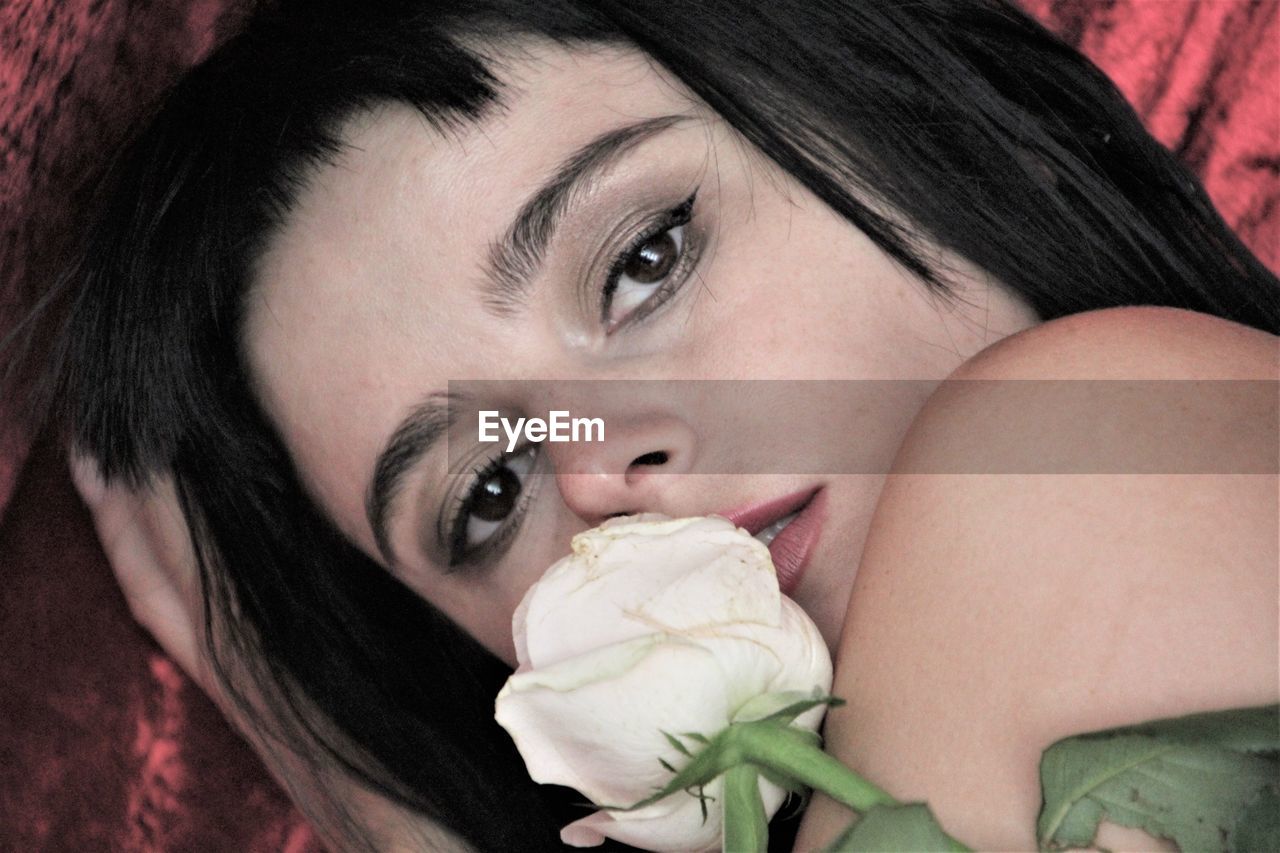 Close-up portrait of woman with flower