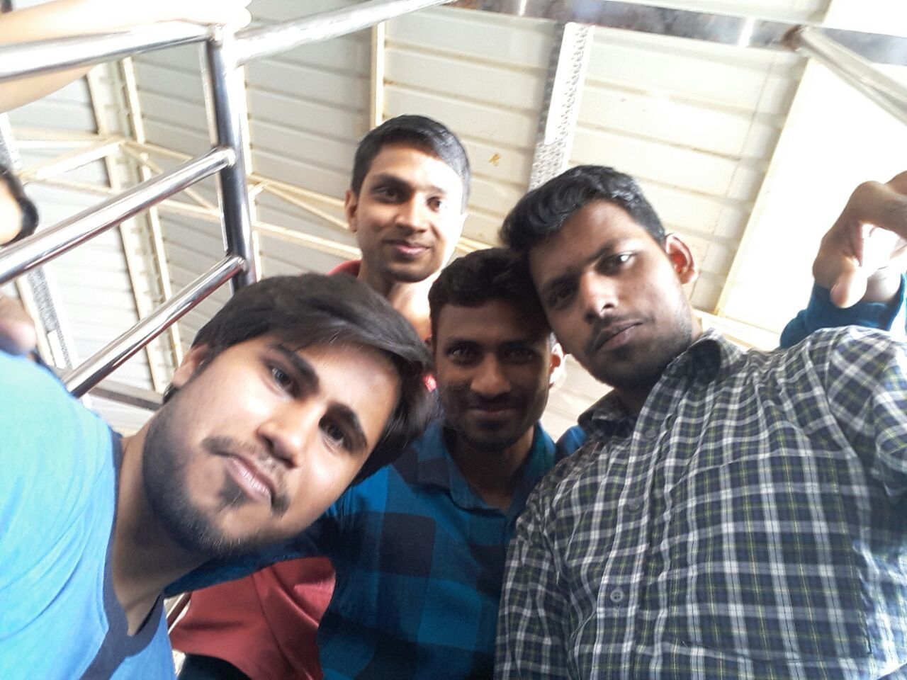 YOUNG MEN LOOKING AT CAMERA WHILE SITTING