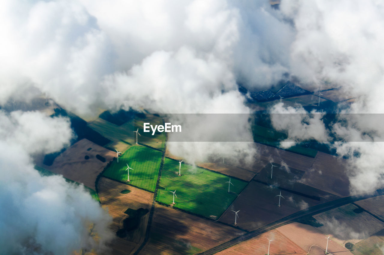 aerial view of cityscape against cloudy sky