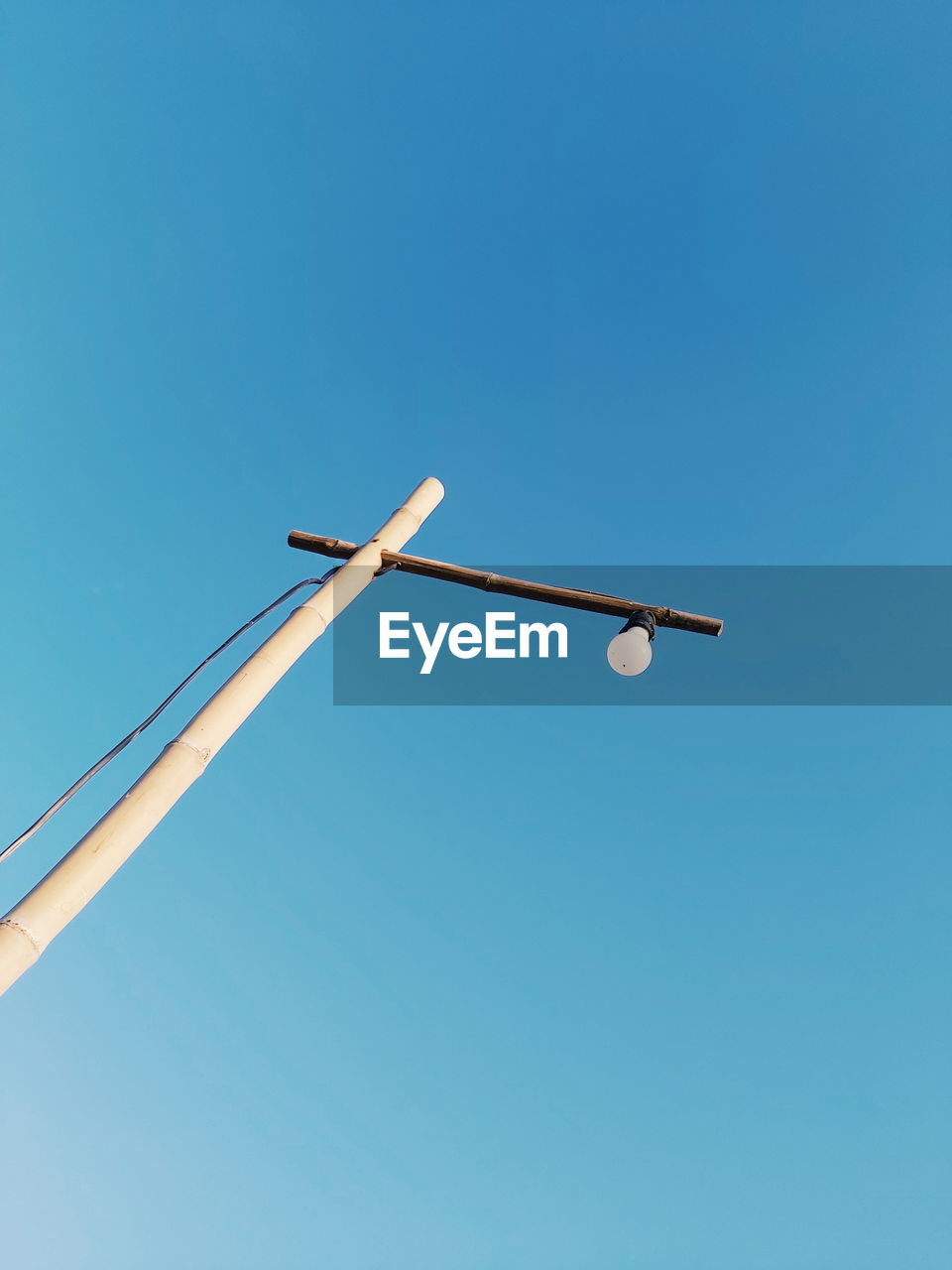 LOW ANGLE VIEW OF STREET LIGHT AGAINST BLUE SKY