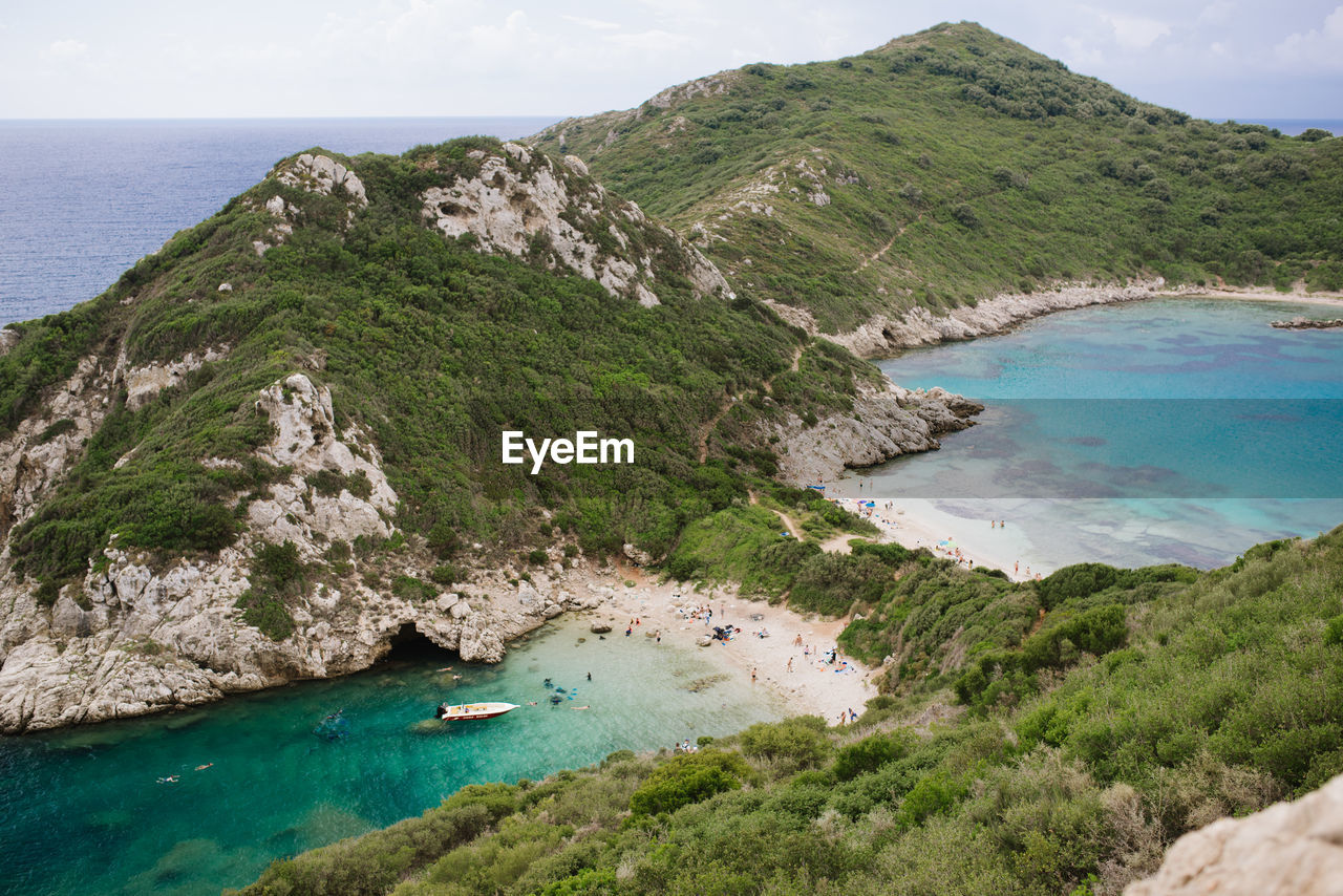 High angle view of sea and mountains against sky