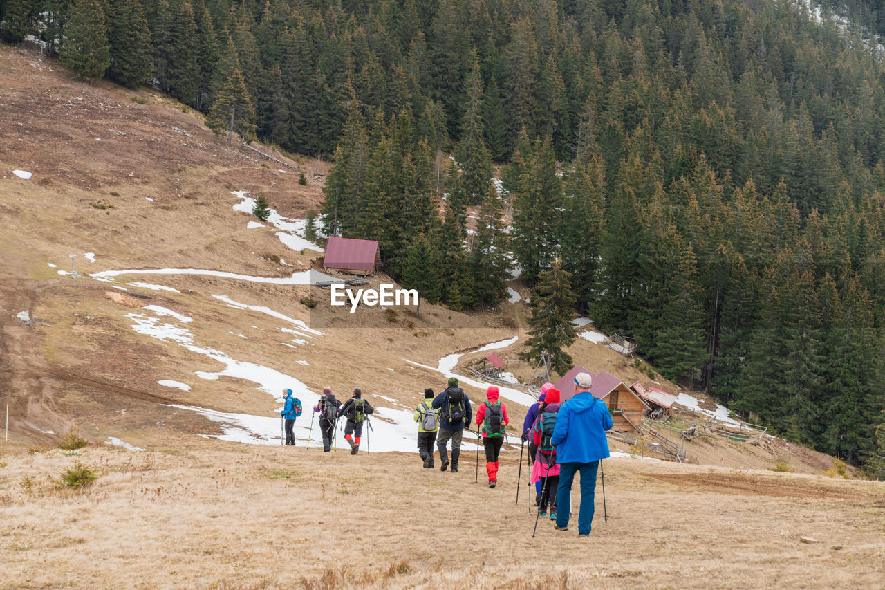 rear view of people walking on mountain