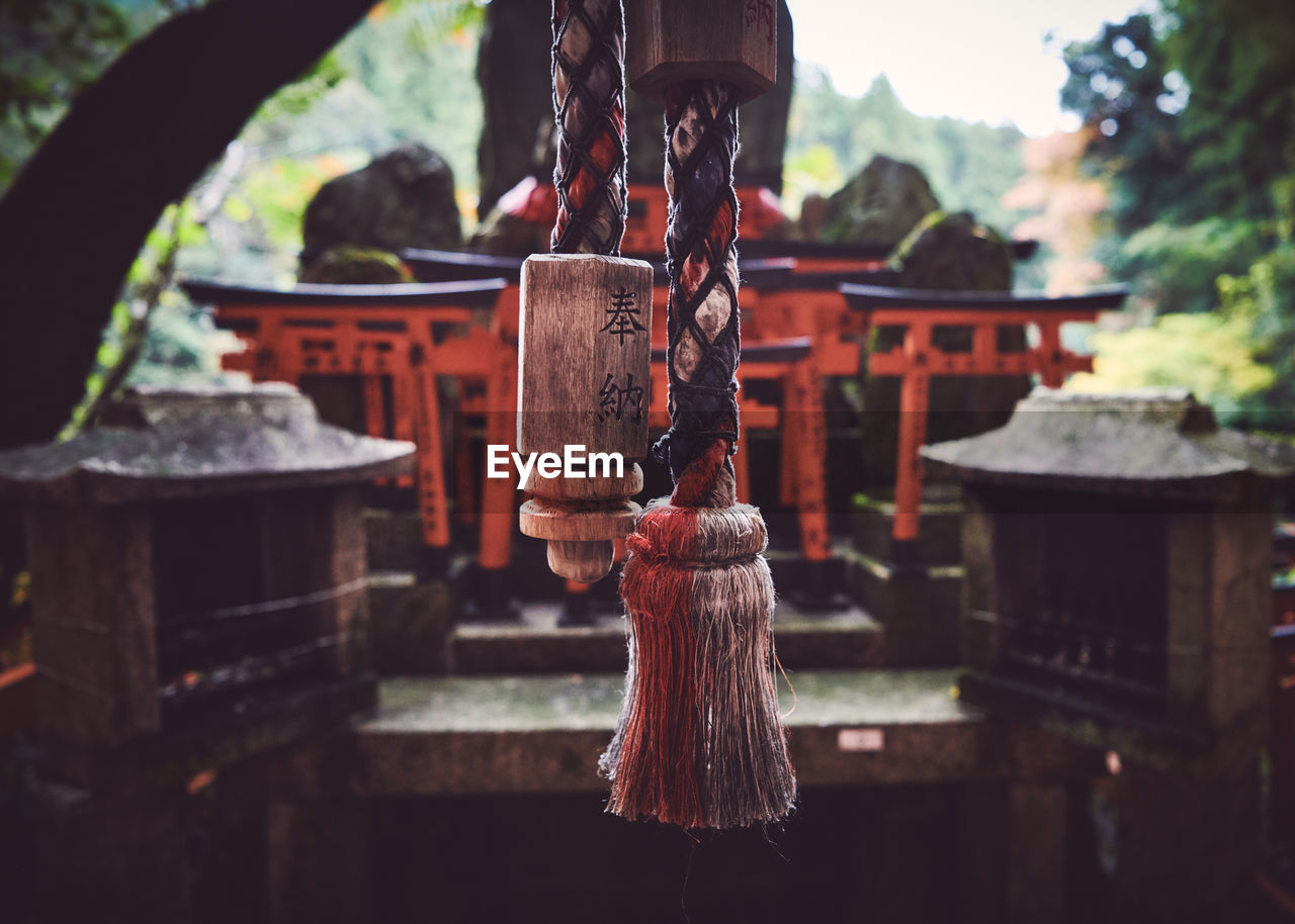 Close-up of bell hanging outside shrine