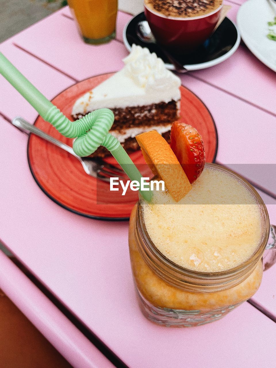 High angle view of cake and juice on table