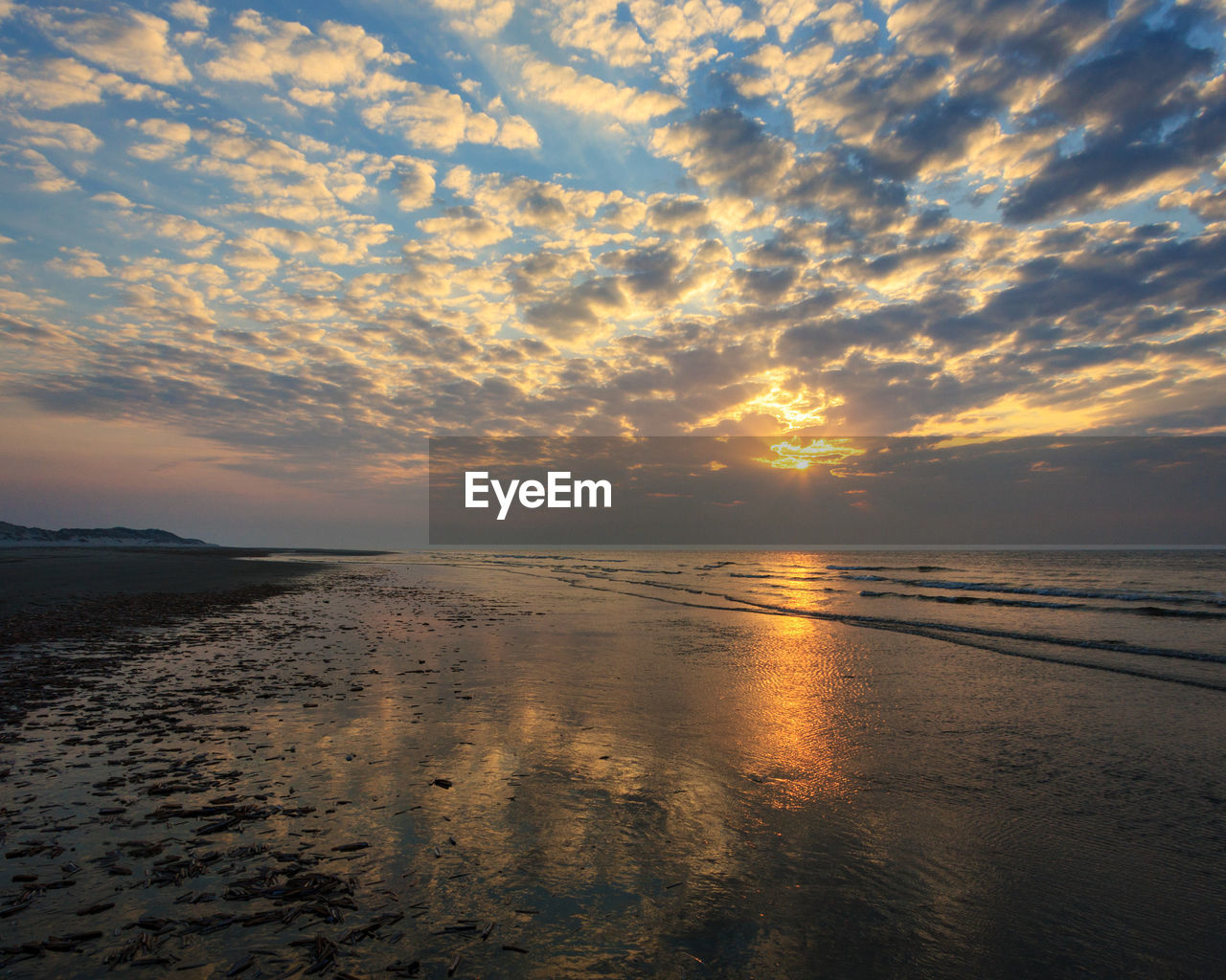 Scenic view of beach against sky during sunset