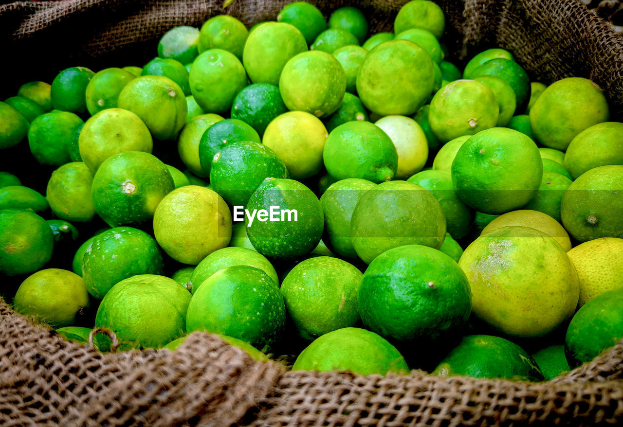 green, food and drink, food, healthy eating, freshness, basket, citrus, fruit, wellbeing, plant, abundance, large group of objects, produce, lime, container, no people, market, wicker, citrus fruit, for sale, retail, market stall, close-up, still life, organic, lemon, day, heap