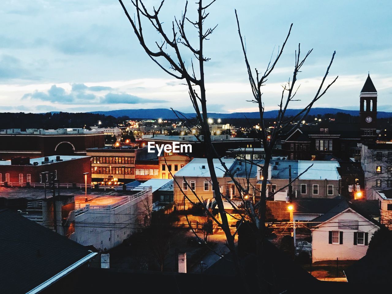 HIGH ANGLE VIEW OF ILLUMINATED BUILDINGS IN TOWN