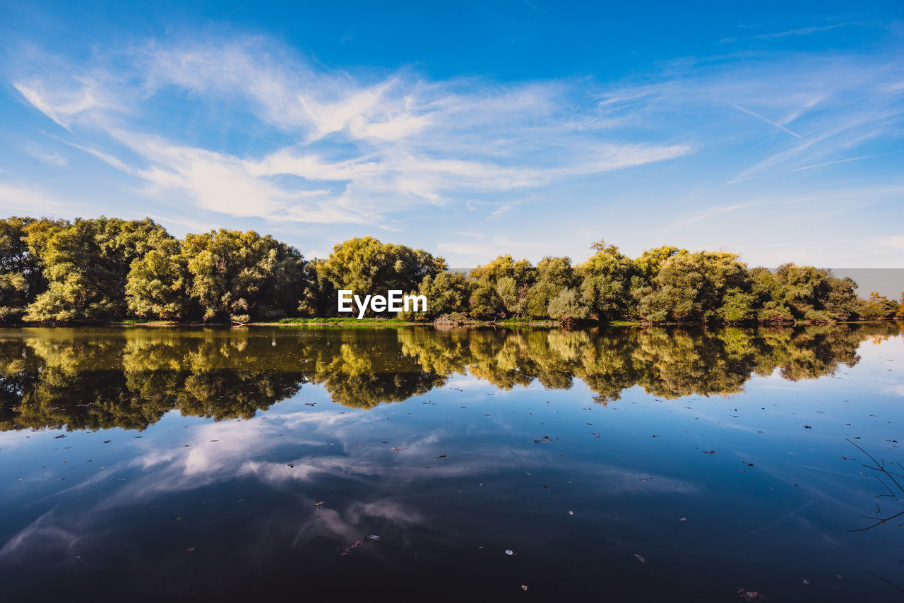 Reflection of trees in lake against sky