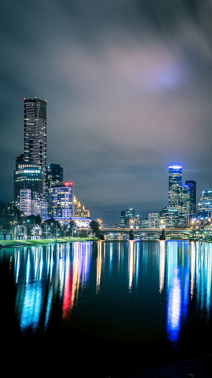 Illuminated city at waterfront