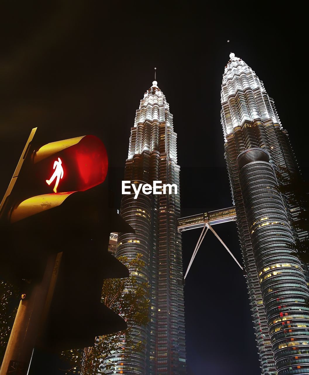 LOW ANGLE VIEW OF ILLUMINATED BUILDINGS AGAINST SKY