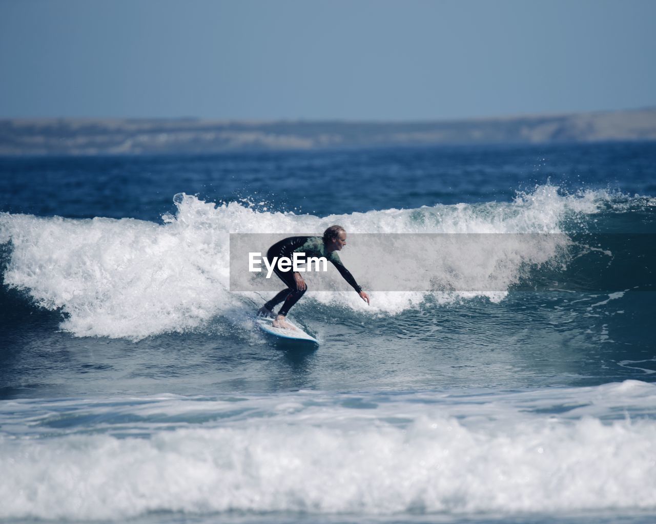 MAN SURFING IN SEA