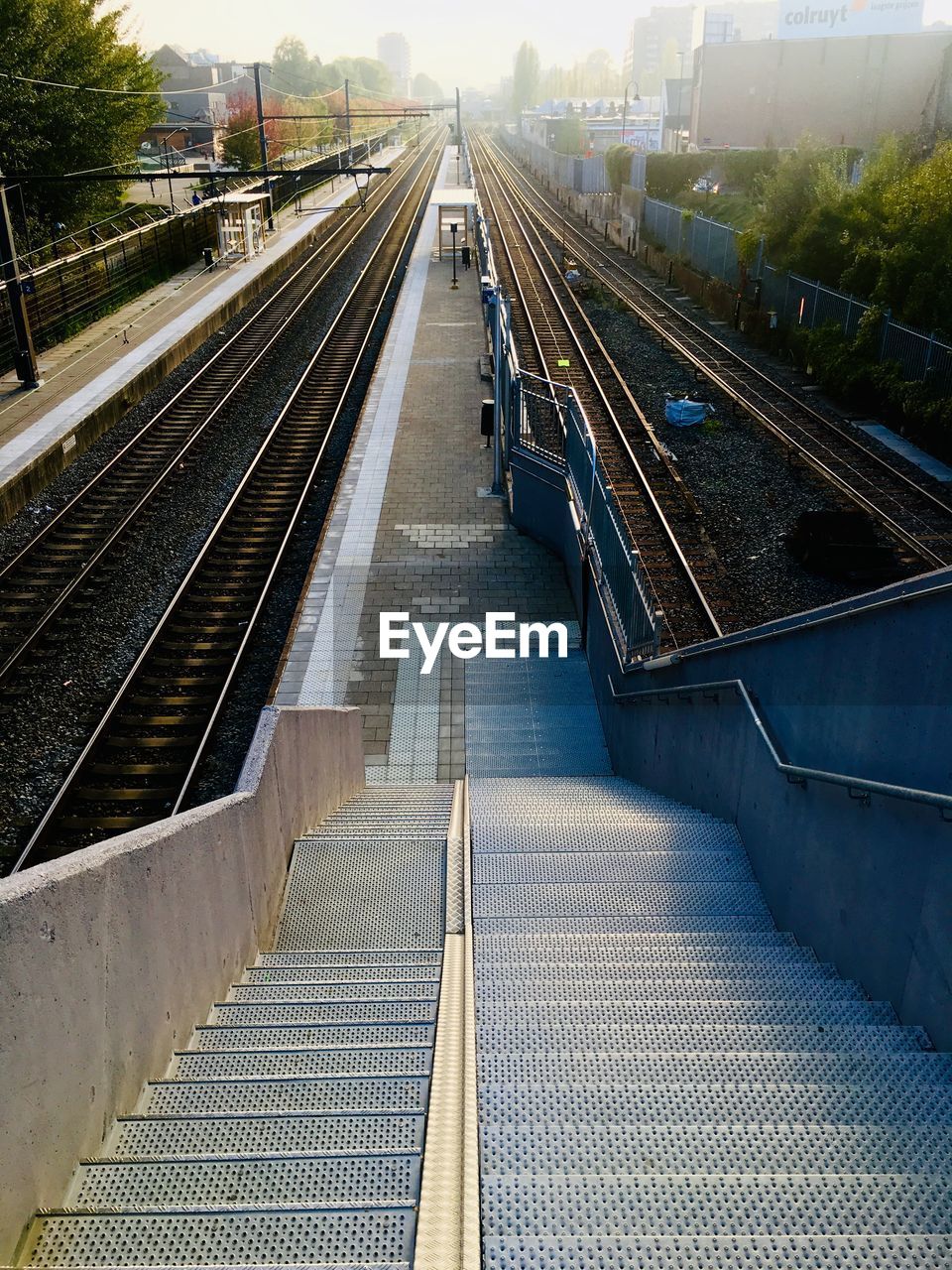 HIGH ANGLE VIEW OF RAILROAD TRACKS AMIDST TRAIN