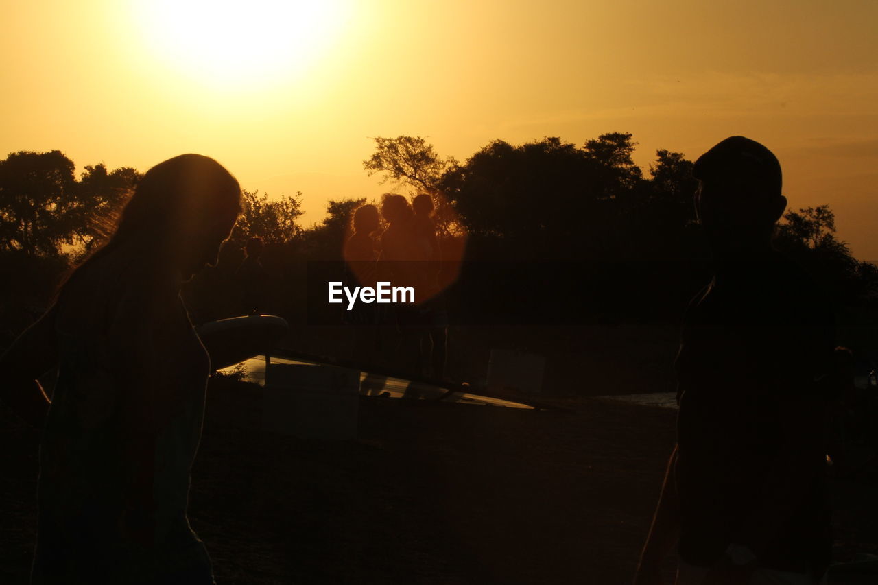 sunset, silhouette, sky, evening, backlighting, nature, dusk, adult, sunlight, orange color, sun, tree, back lit, outdoors, lifestyles, men, light, plant, leisure activity