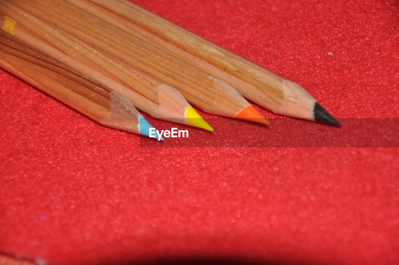pencil, red, writing instrument, no people, close-up, still life, indoors, colored pencil, sharp, wood, paper, craft, creativity, wing, high angle view, education, multi colored, table