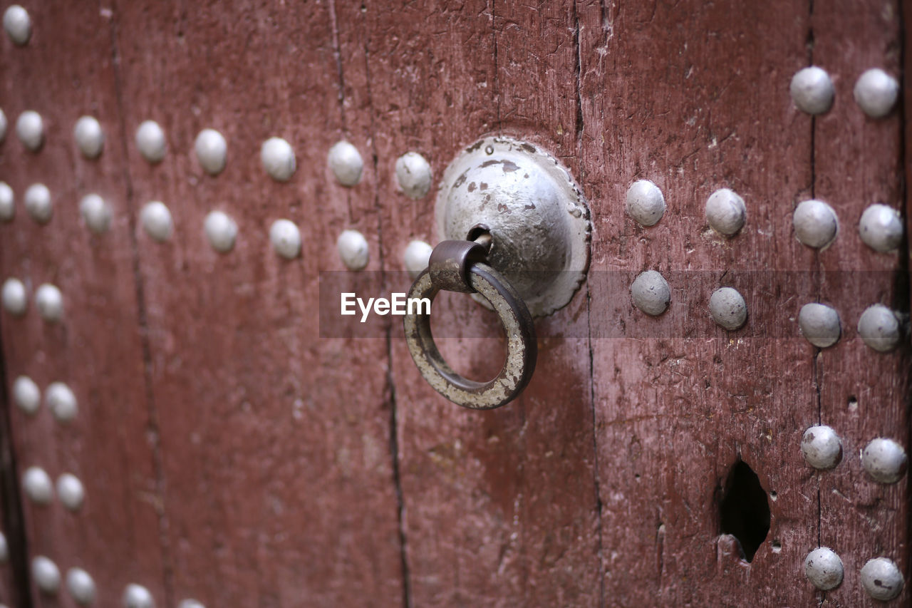 Full frame shot of red moroccan door with metal door knocker