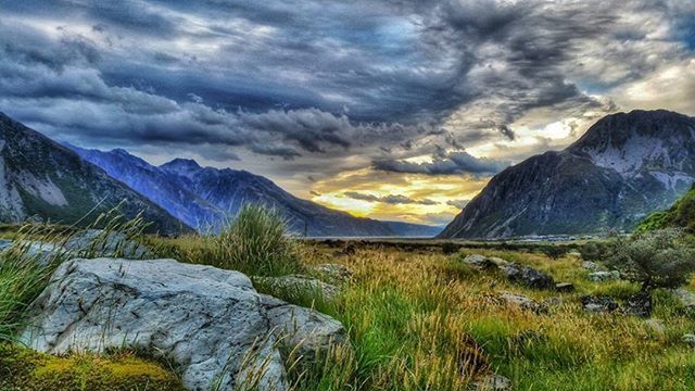 SCENIC VIEW OF MOUNTAINS AGAINST CLOUDY SKY