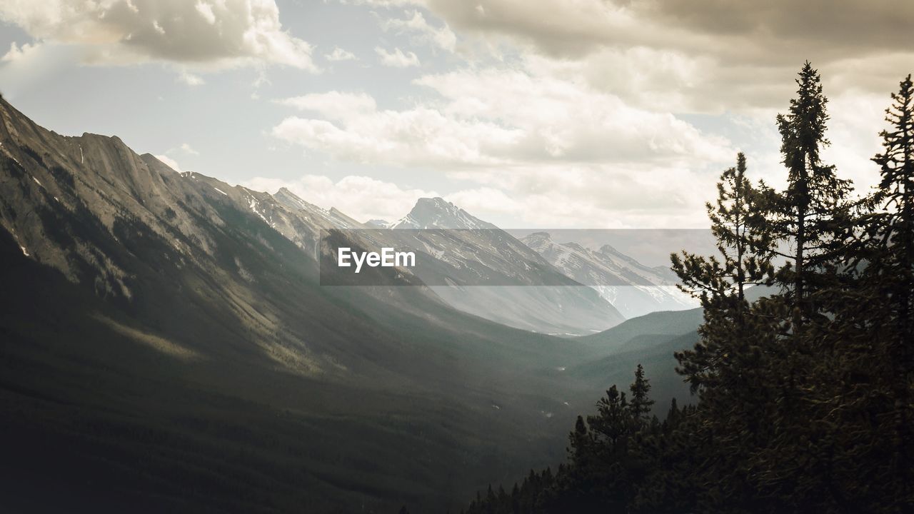 Scenic view of mountains against cloudy sky