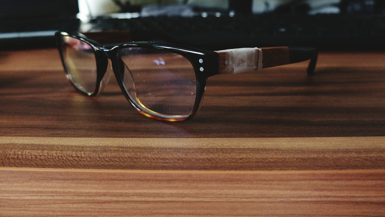 Close-up of glasses on wooden table