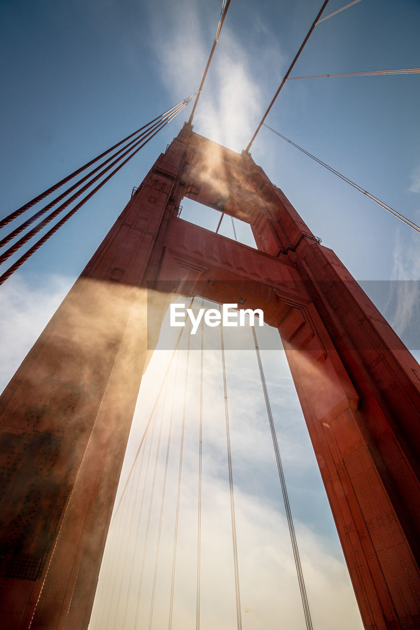 View of one of the foggy red columns of the san francisco bridge.