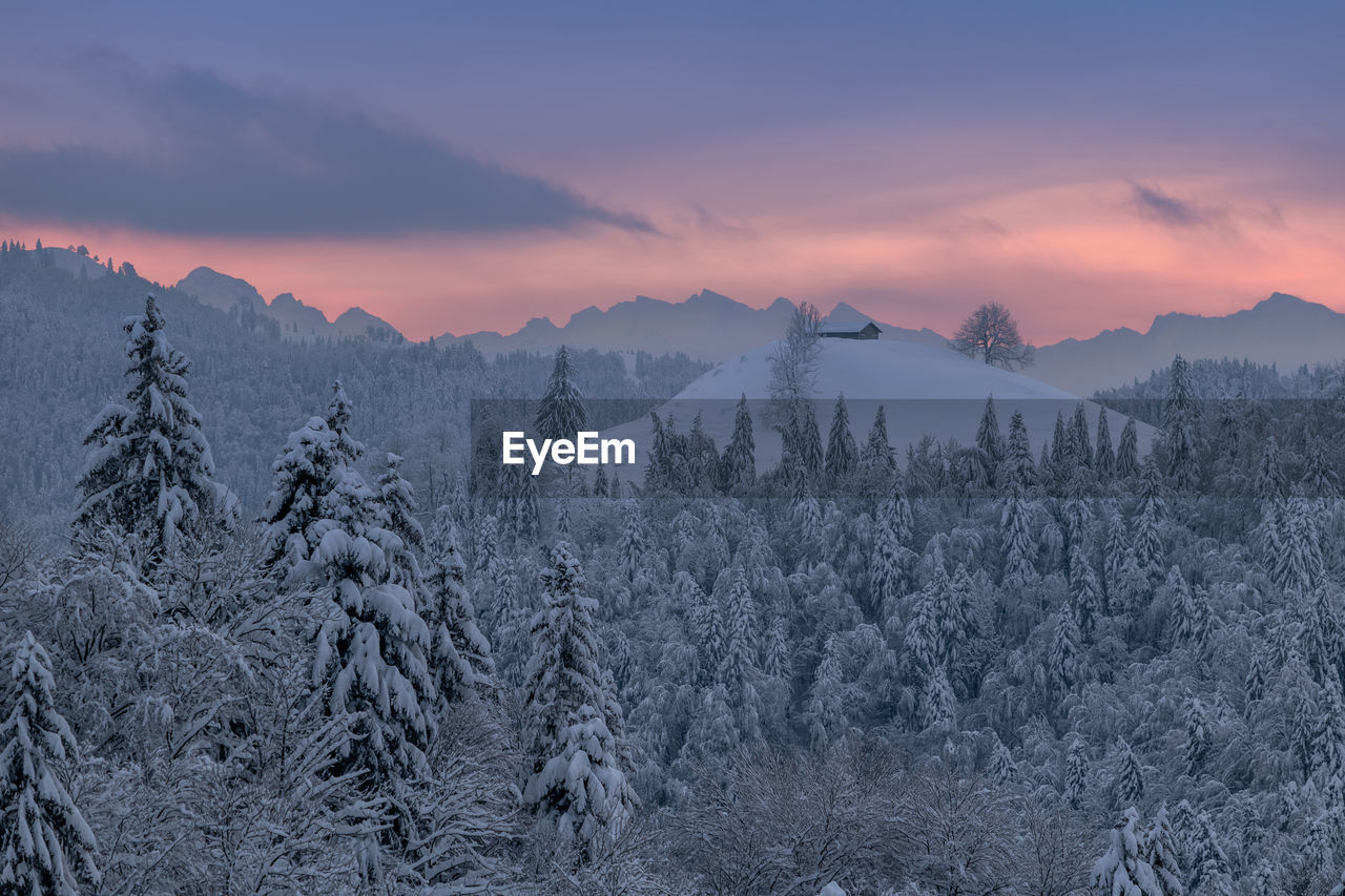 Scenic view of snow mountains against sky during sunset