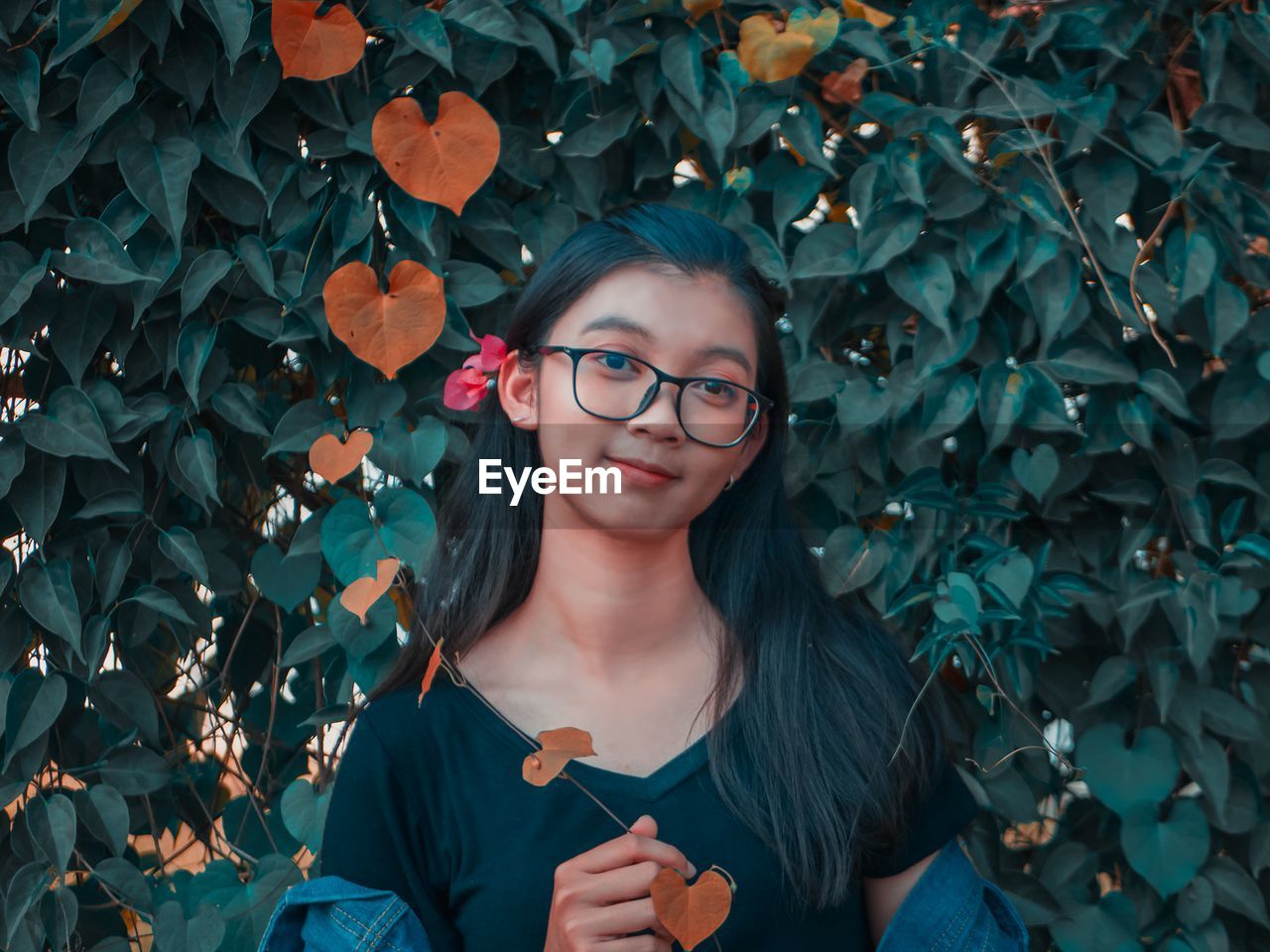 Portrait of woman by plants