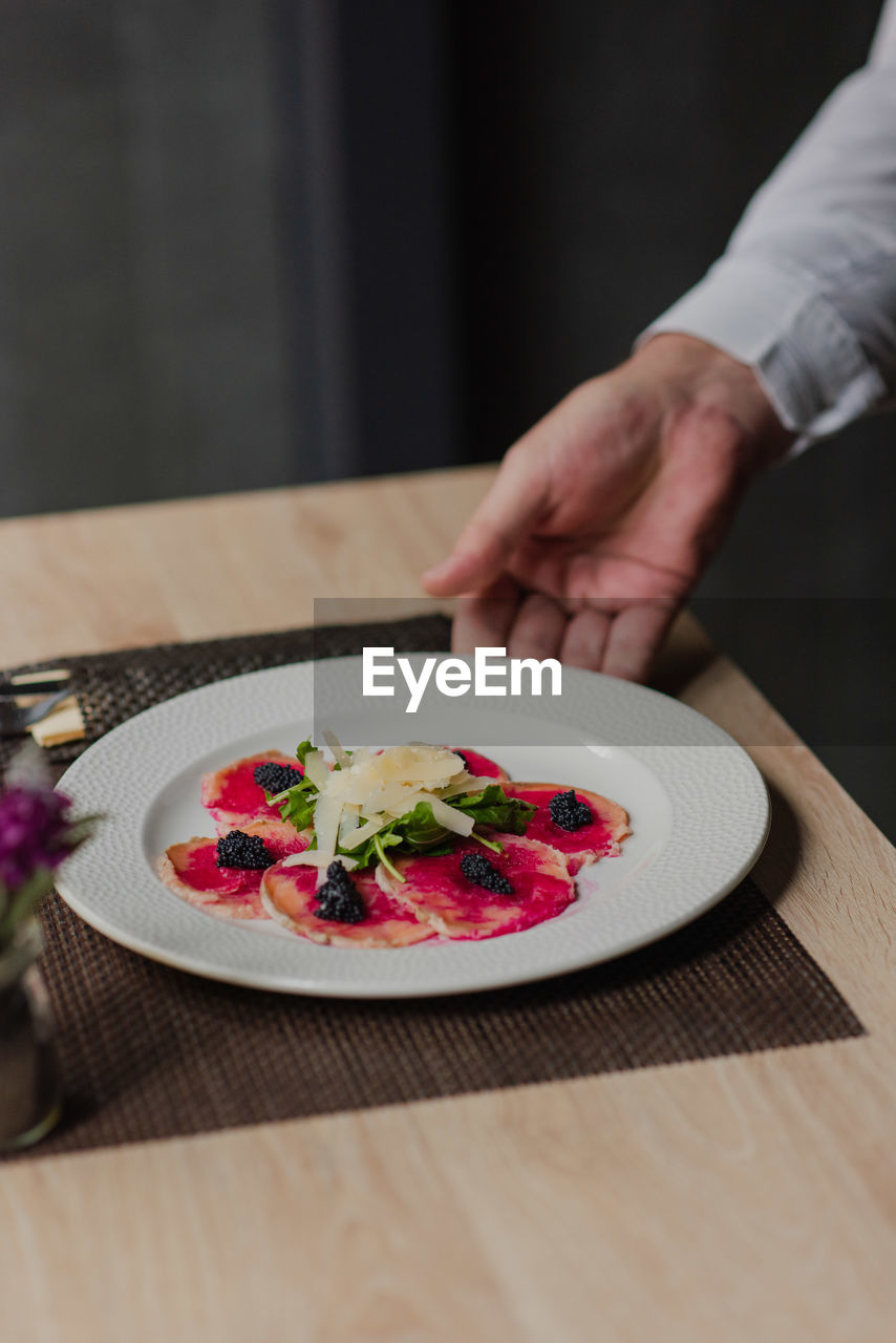 cropped hand of person having food