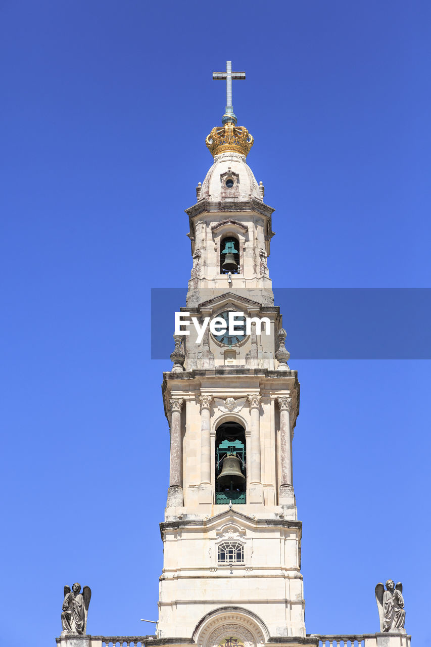 low angle view of bell tower against clear blue sky