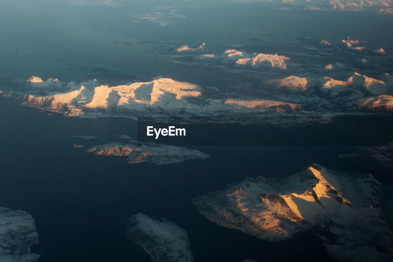 Aerial view of mountain range against sky during sunset