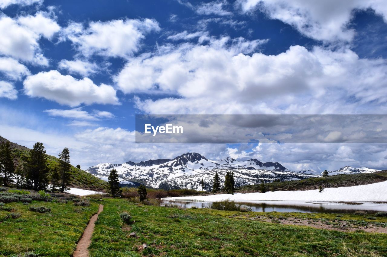 Scenic view of snowcapped mountain against cloudy sky