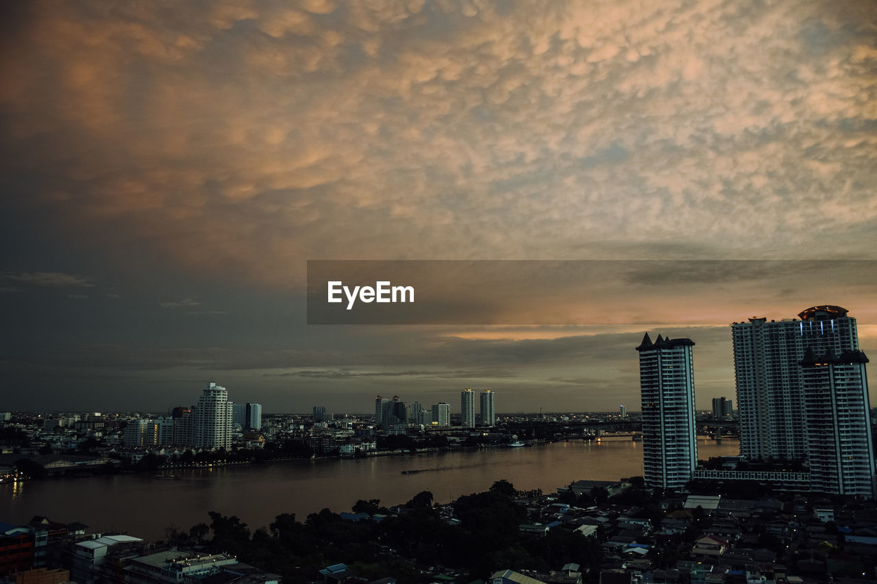 ILLUMINATED BUILDINGS AGAINST SKY DURING SUNSET