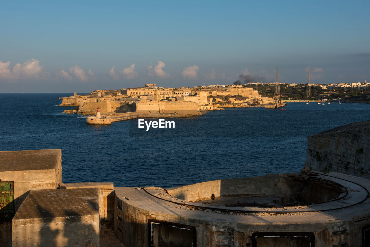 Fort on sea against blue sky