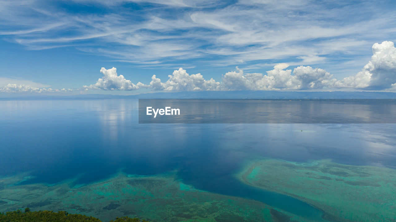 Aerial drone of the island of cebu from the sea. blue ocean and sky with clouds. 