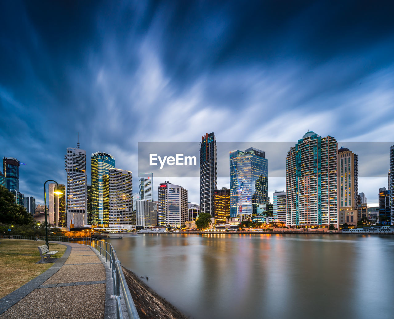 Illuminated buildings by city against sky