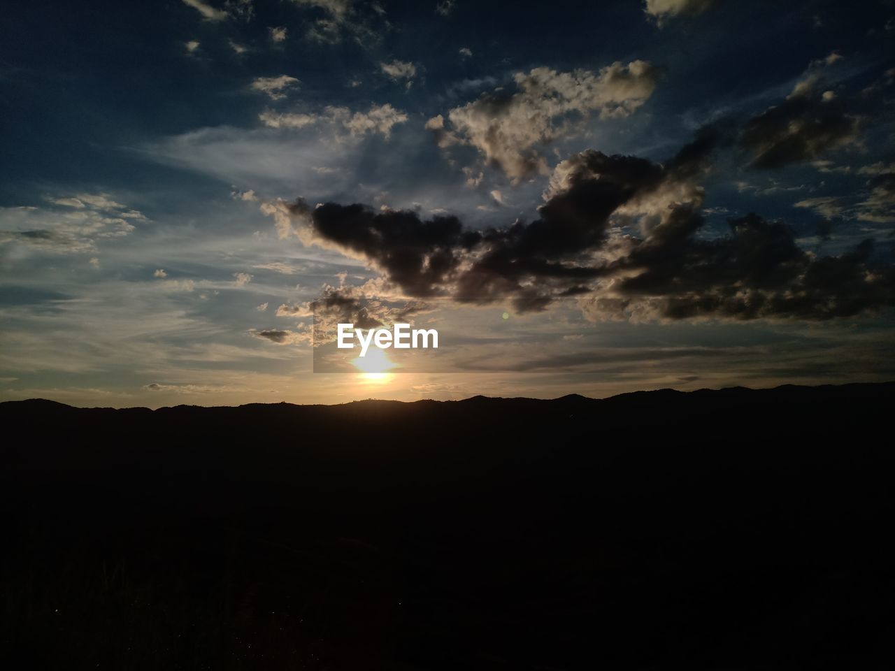 SCENIC VIEW OF SILHOUETTE LANDSCAPE AGAINST DRAMATIC SKY