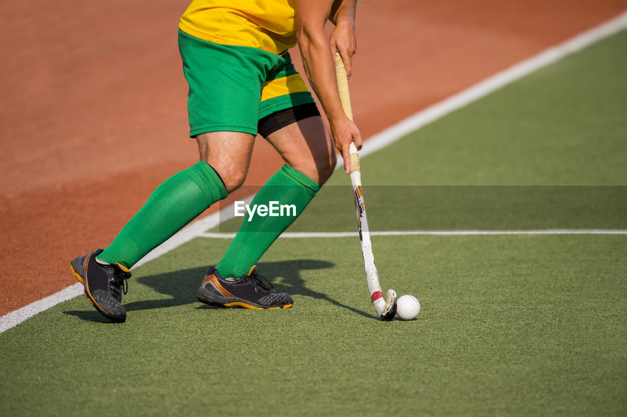 Low section of man playing hockey