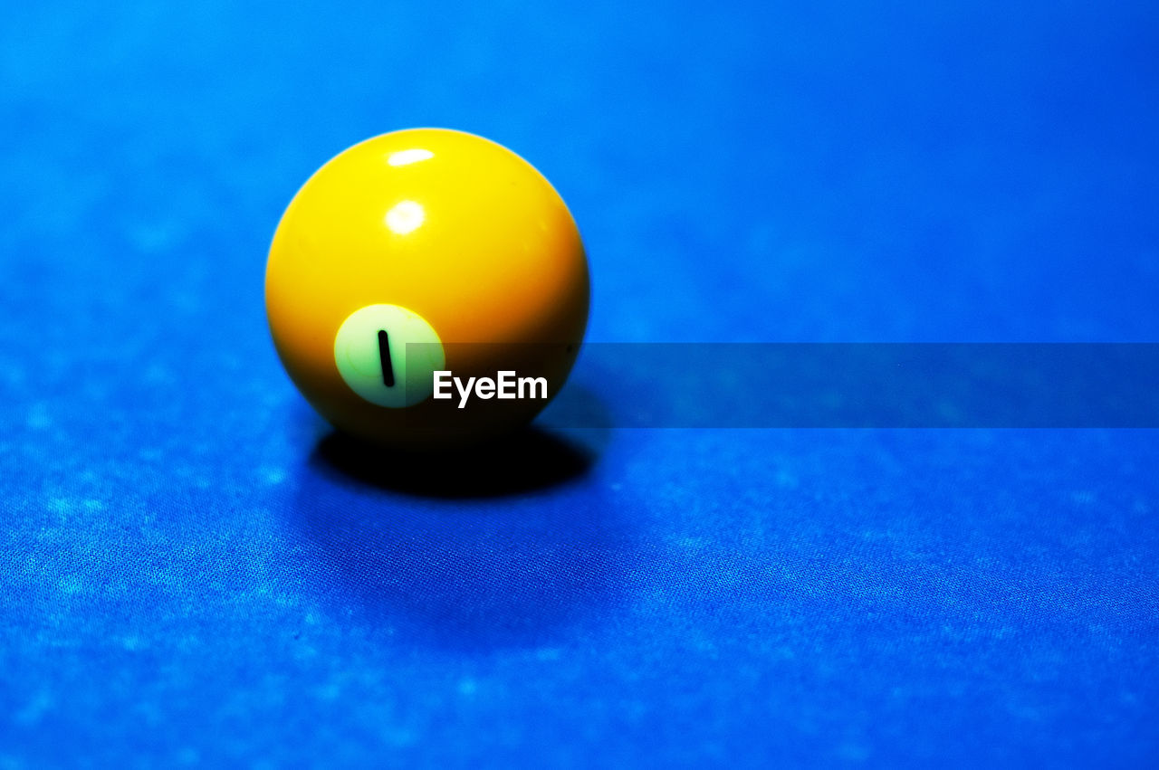 High angle view of yellow pool ball on table