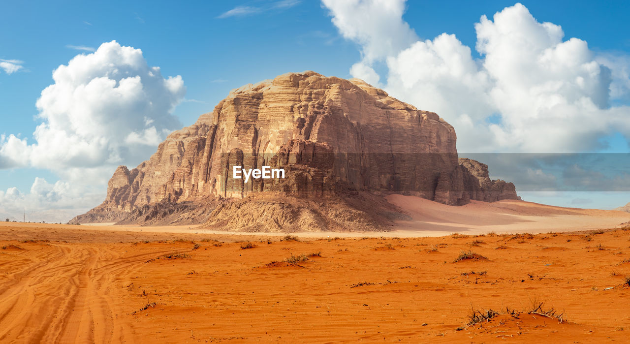 Red sands and huge rock in the middle, wadi rum desert, jordan