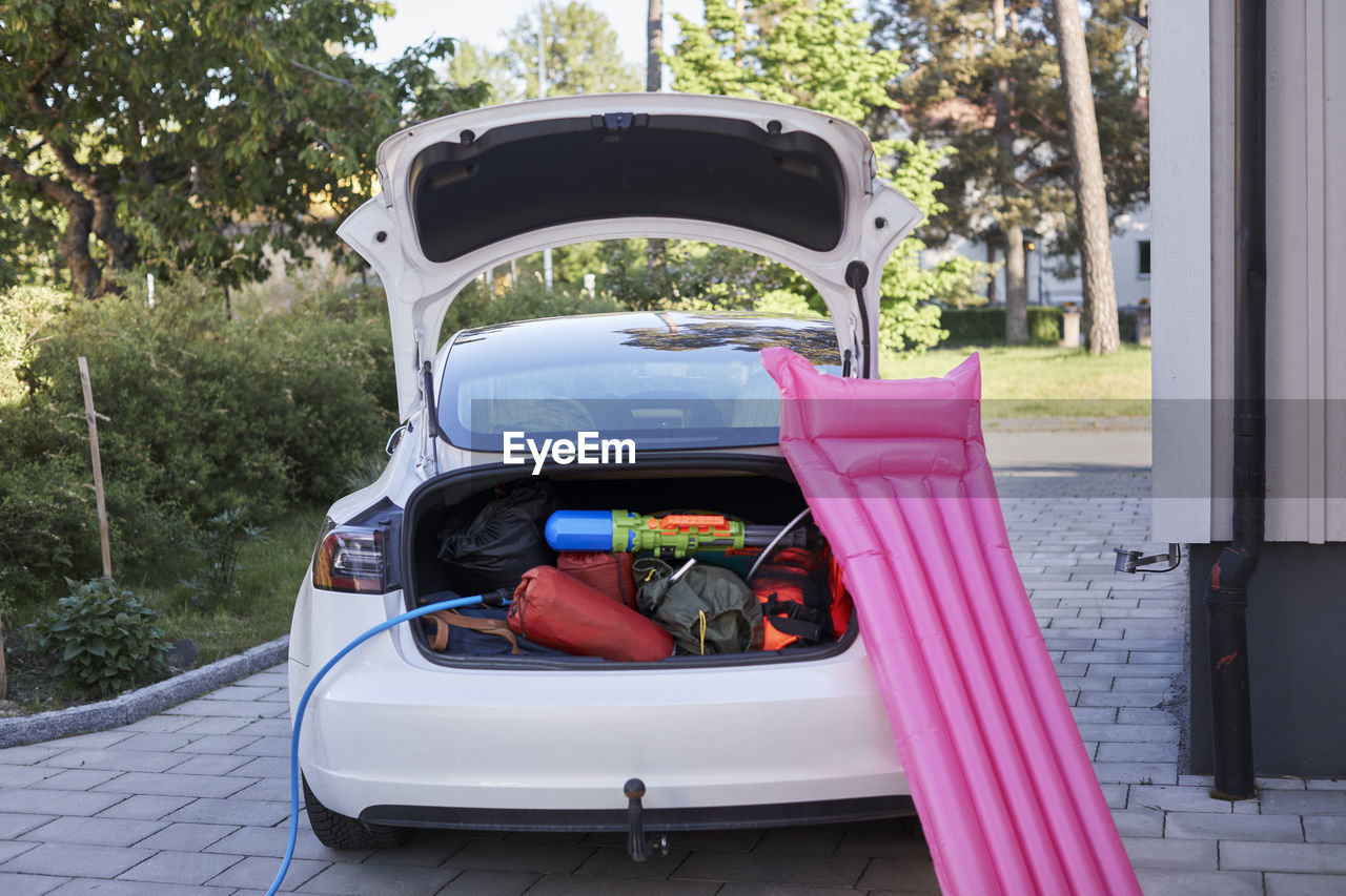 Inflatable raft leaning on electric car