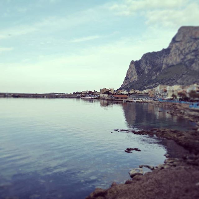 SCENIC VIEW OF SEA WITH MOUNTAIN IN BACKGROUND