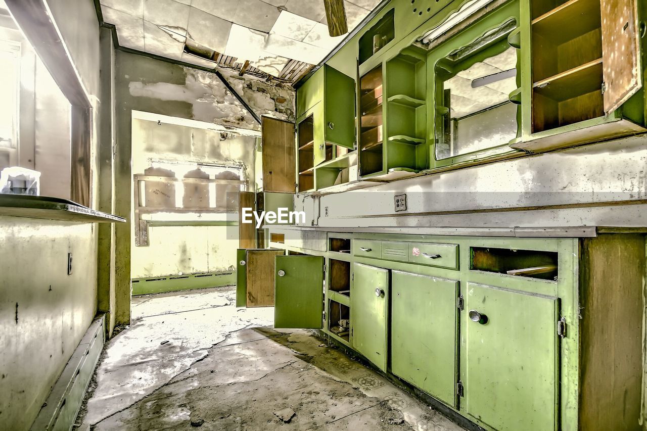 Abandoned domestic kitchen with cabinets