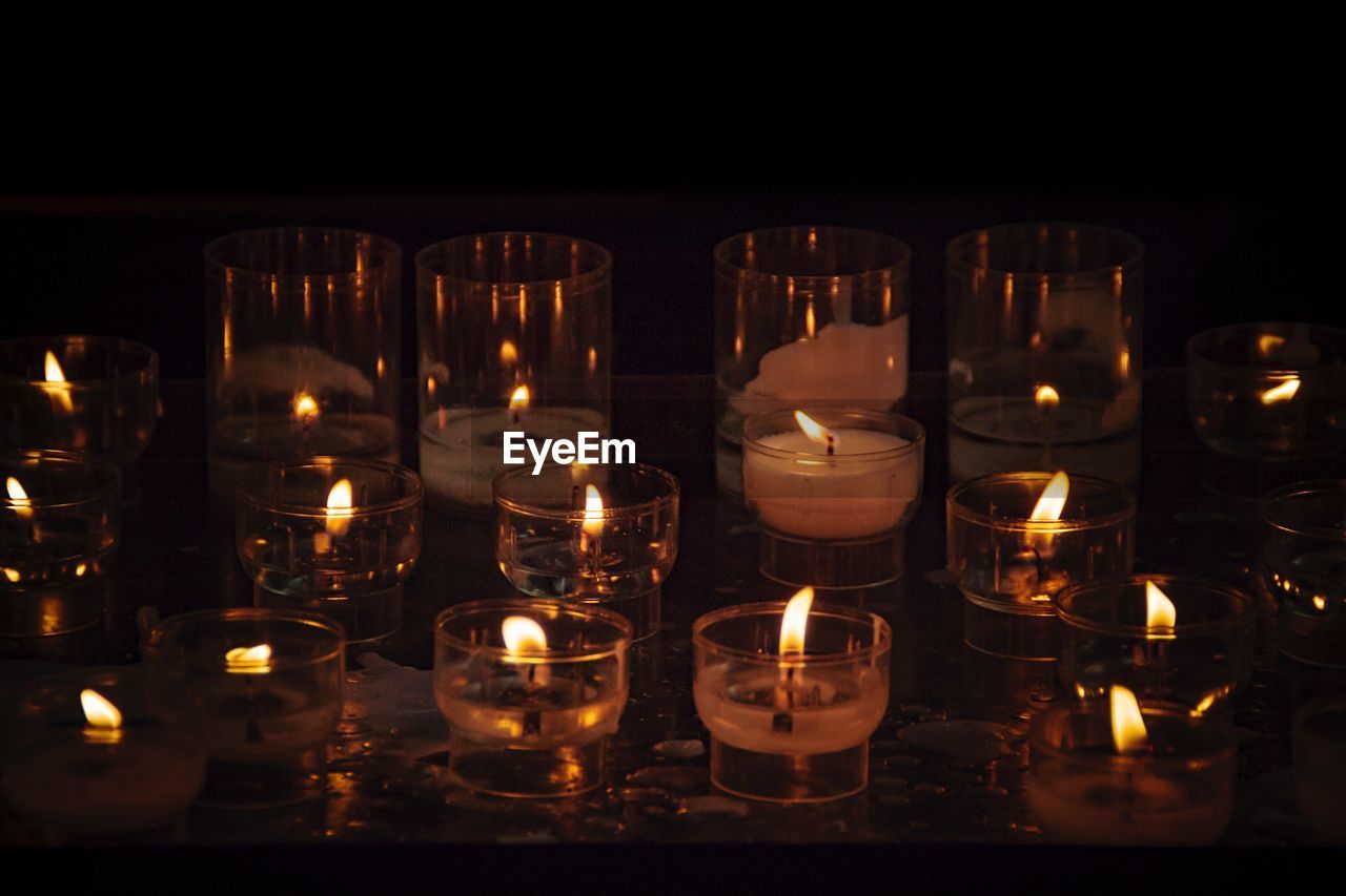 Illuminated tea light candles in temple