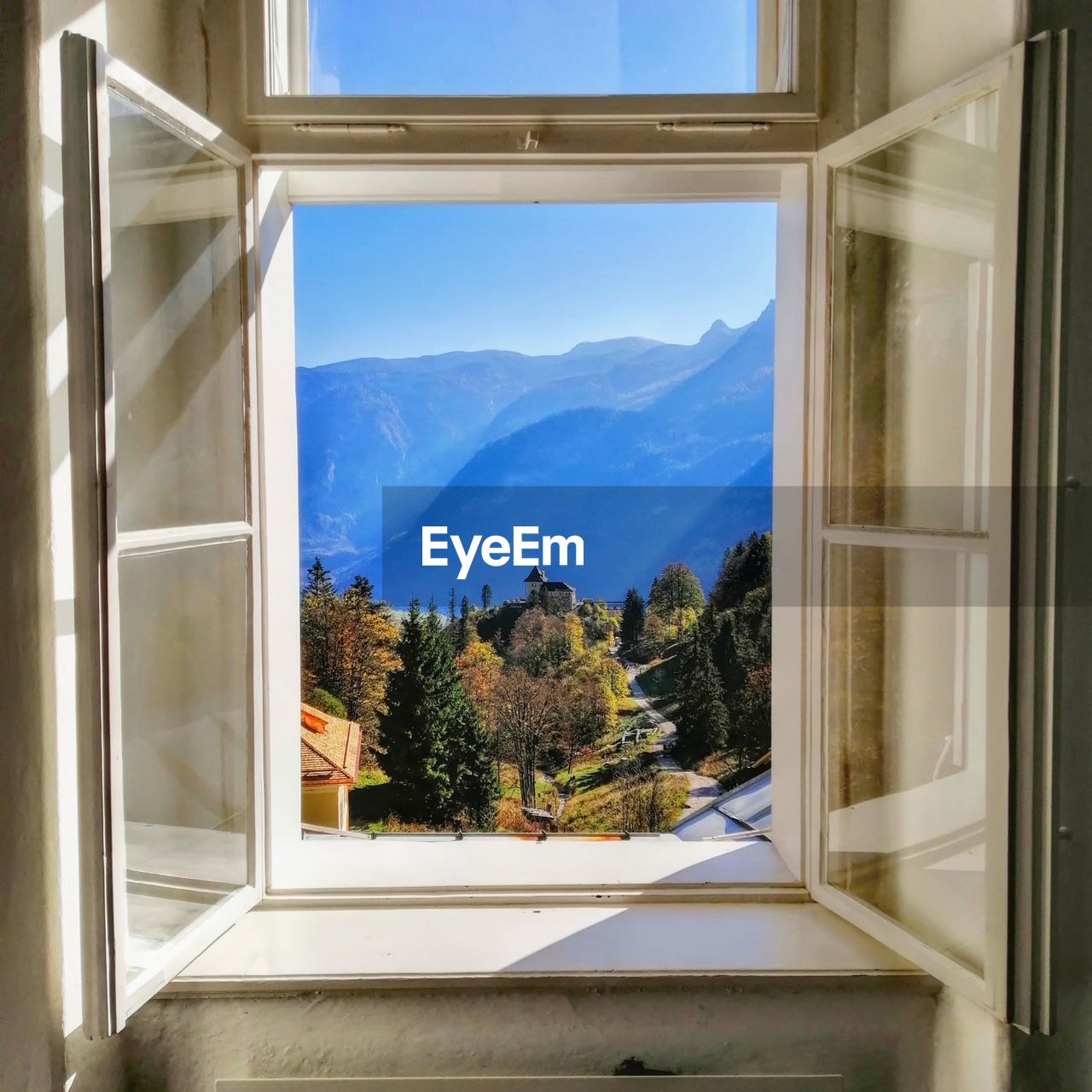 Trees and mountains seen through window