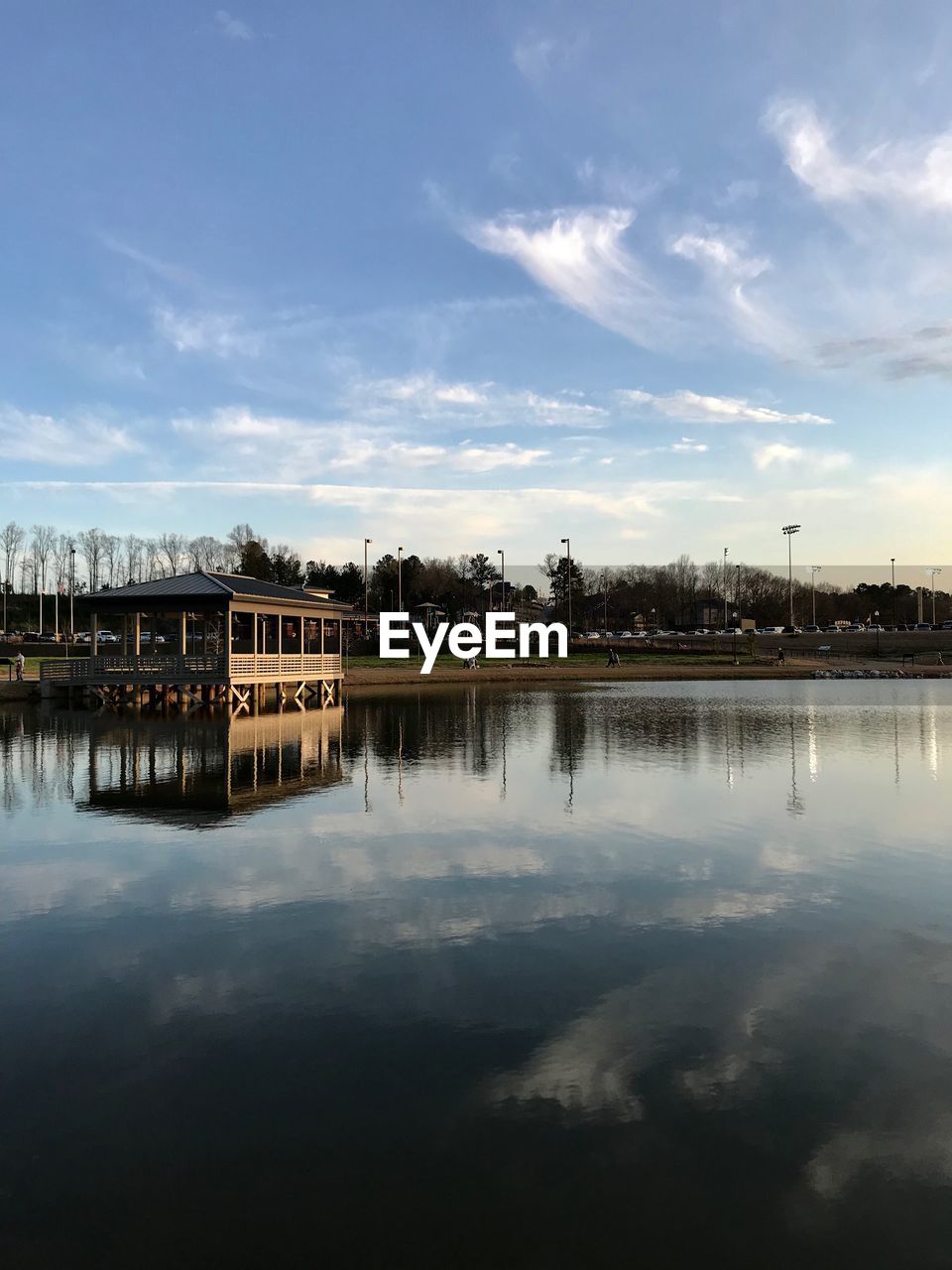 Reflection of building in lake against sky