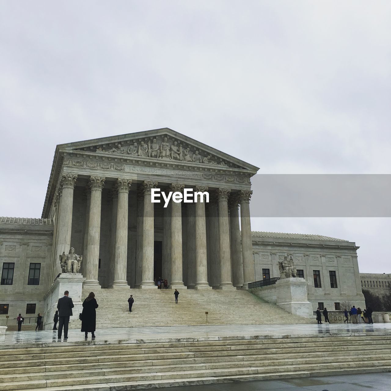 People at supreme court against sky